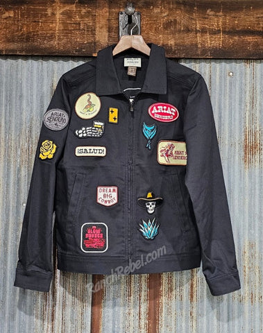 Black jacket with various patches on a wooden background